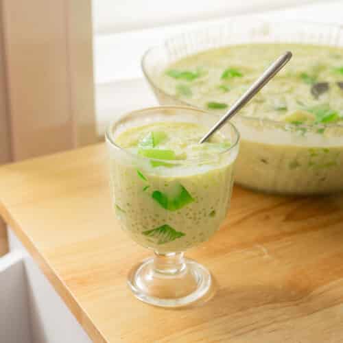 Buko pandan in a glass serving cup on a wooden table.