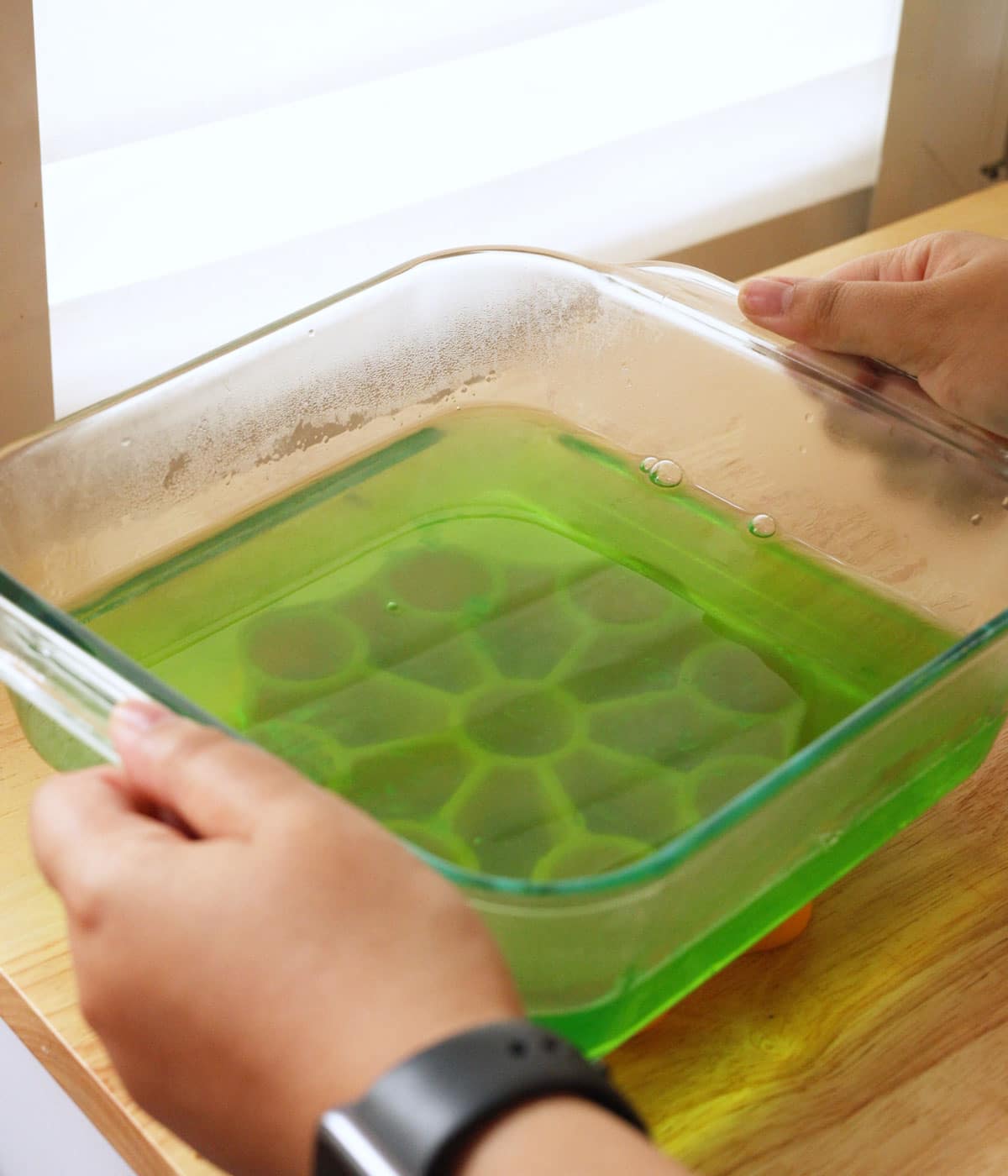 Liquid buko pandan jelly mixture in a glass container, ready to chill in the fridge.