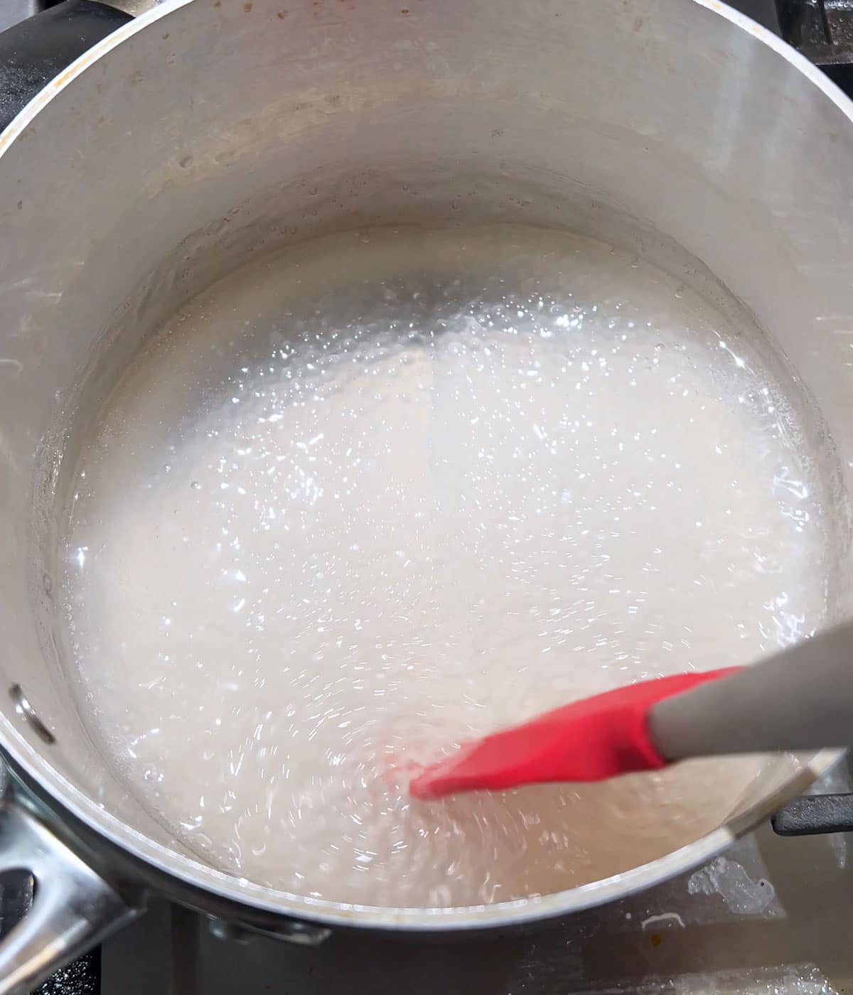 Cooked sago pearls in a stainless steel pot.