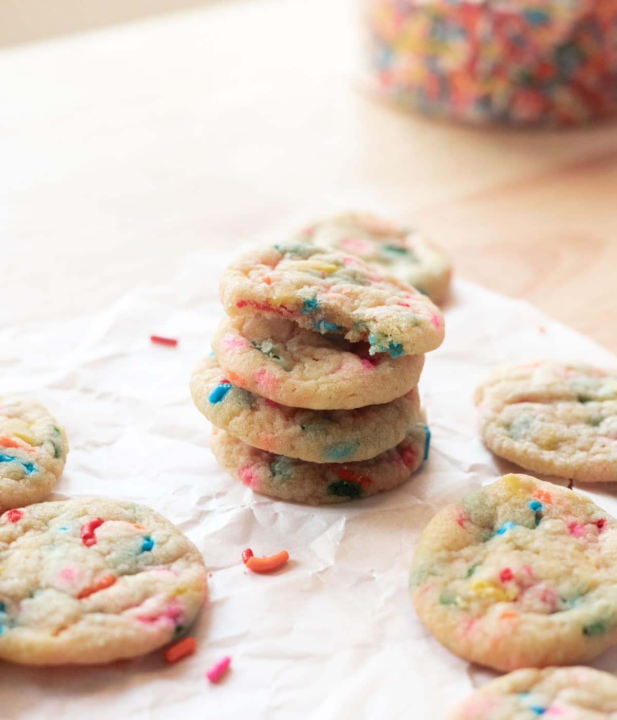 Mini funfetti cookies stacked on top of one another.