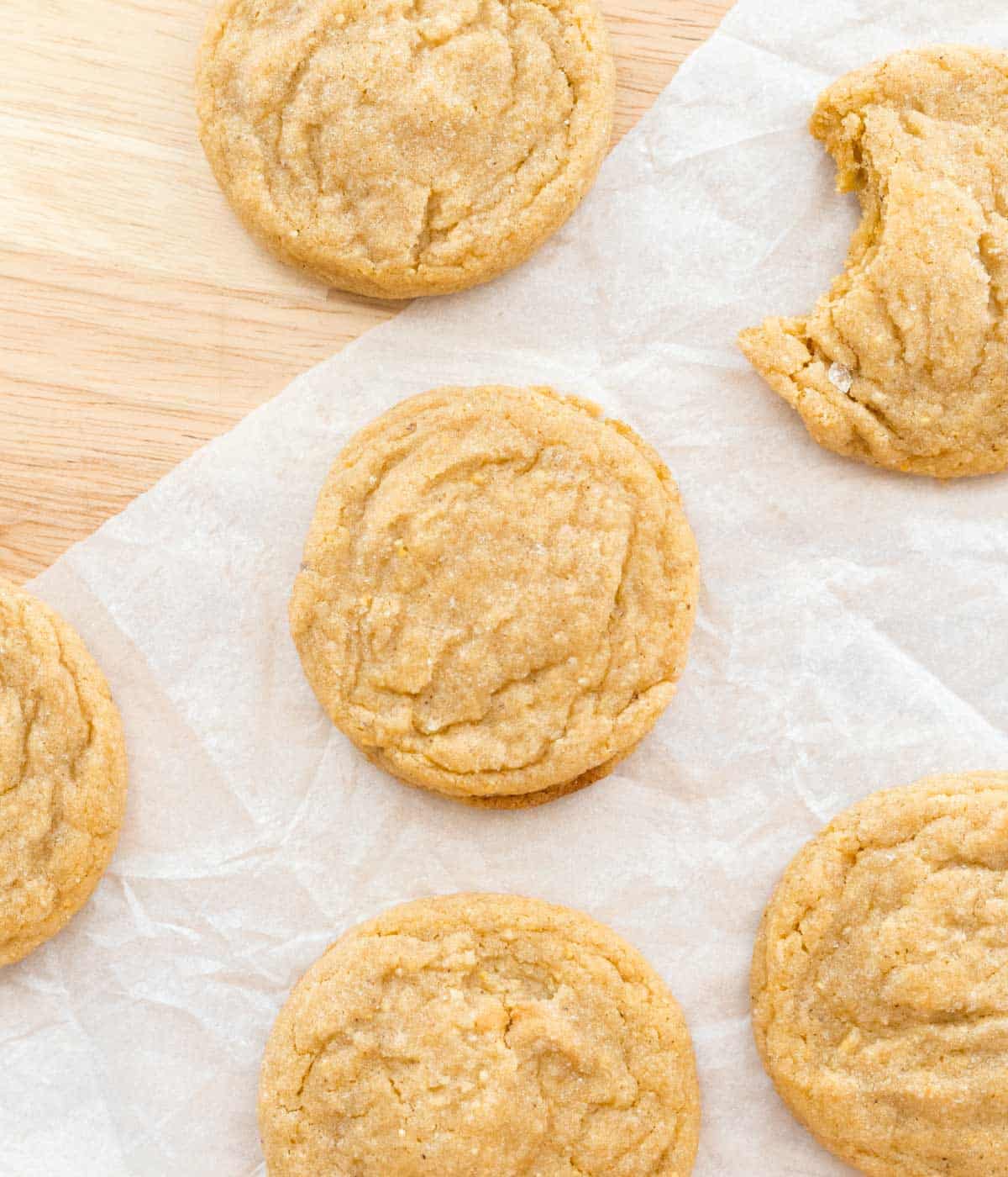 Corn sugar cookies spread across parchment paper.