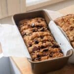 Sliced chocolate chip banana bread in loaf pan.