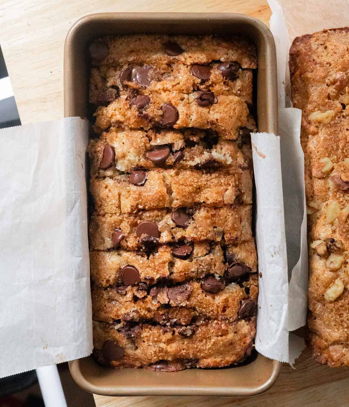 Sliced chocolate chip banana bread in loaf pan.