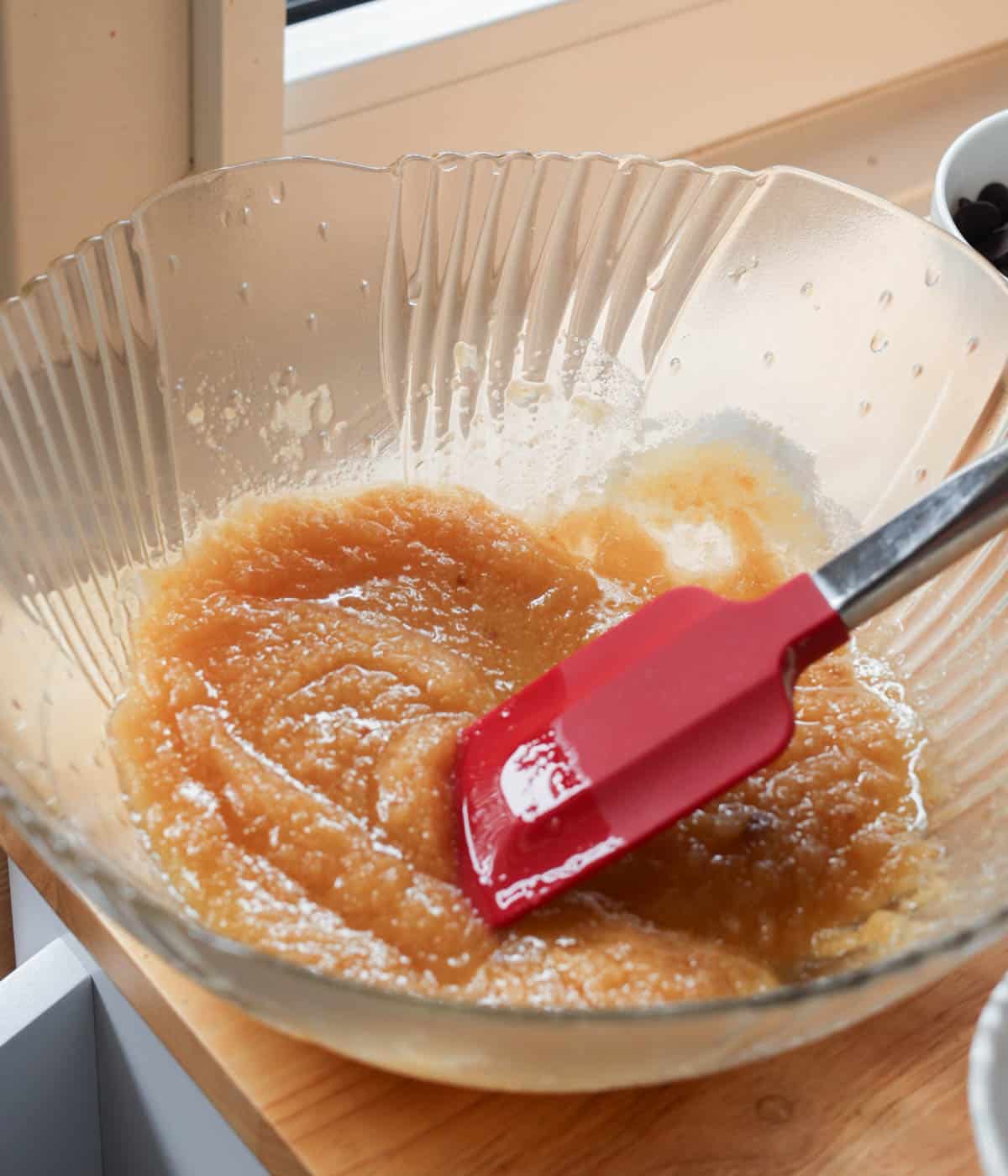 Butter and sugars mixed together in glass bowl.