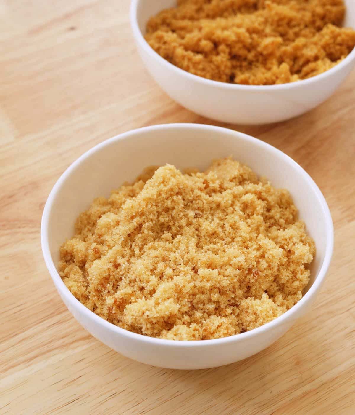 Light brown sugar in a white bowl.