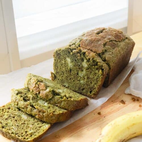 Matcha banana bread with half of it cut into slices.