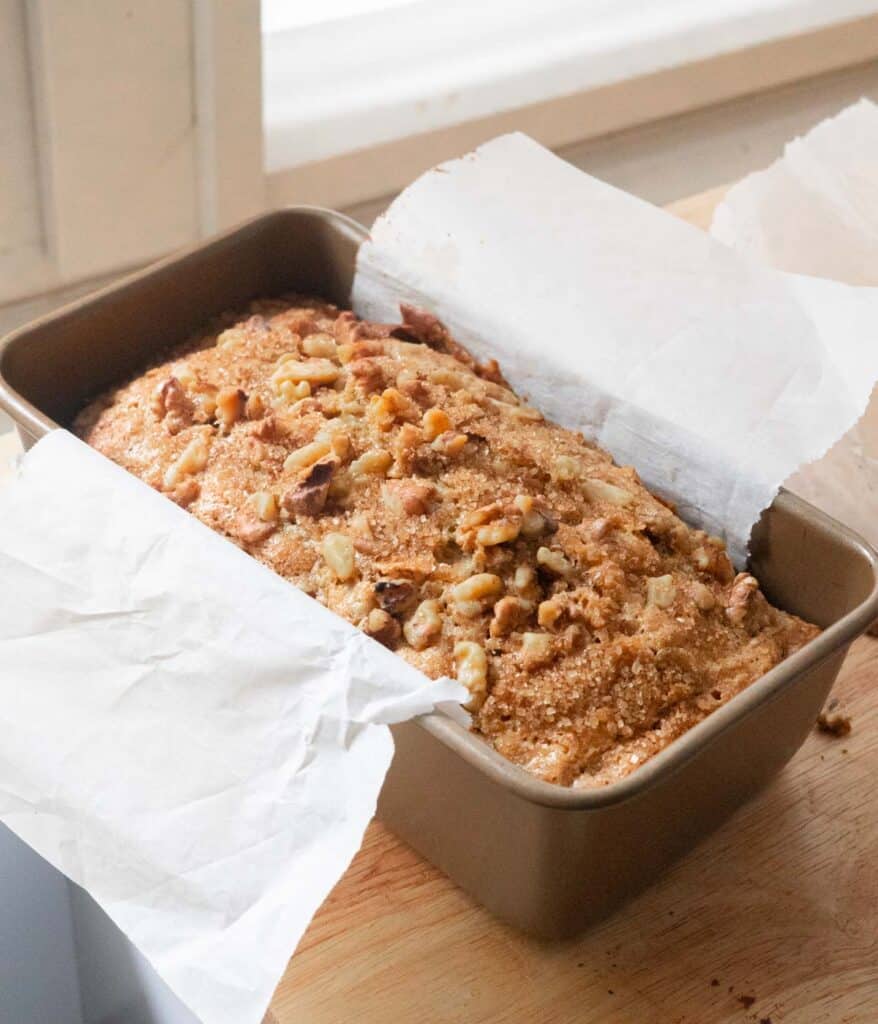 Golden brown walnut banana bread in loaf pan.