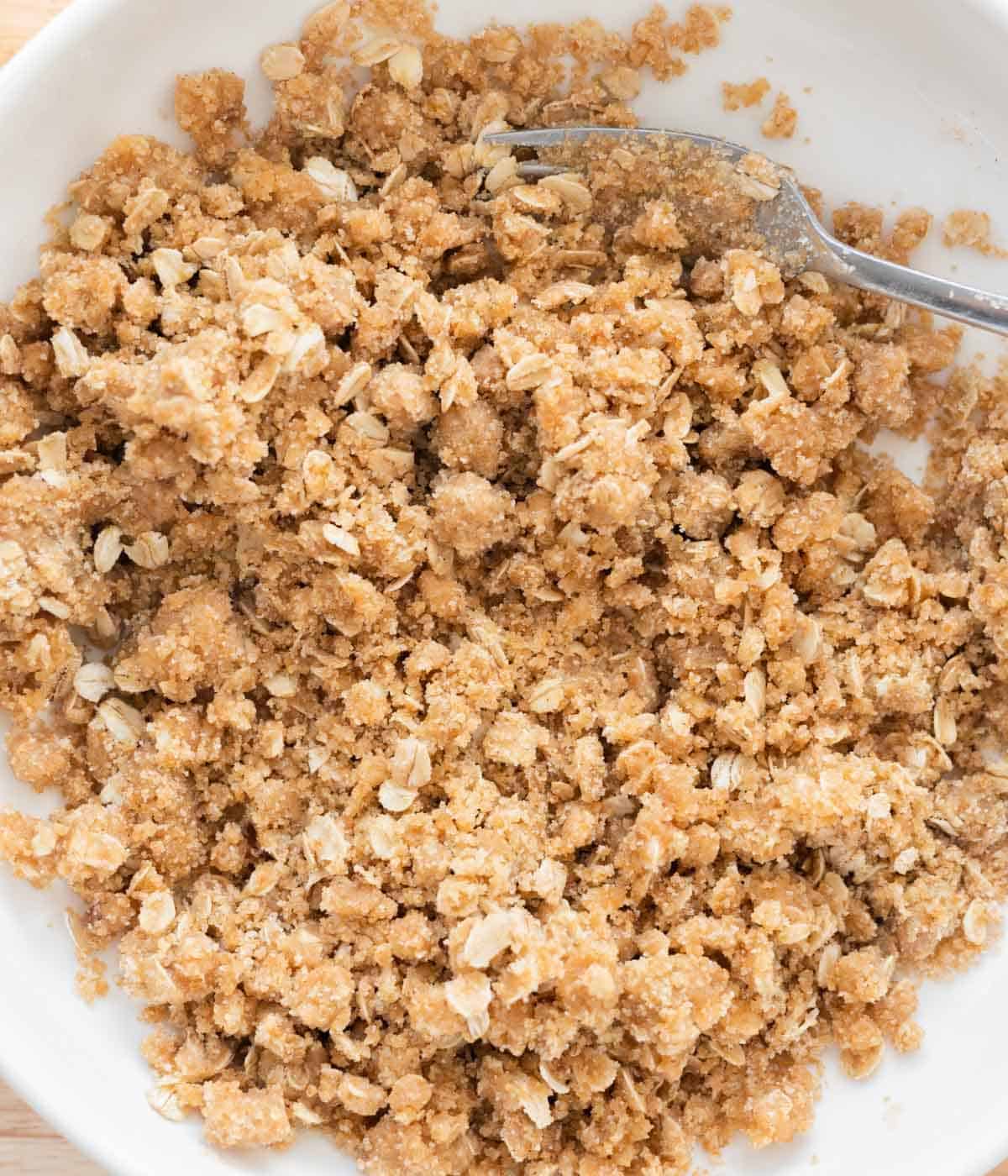 Homemade crumble topping in white bowl.