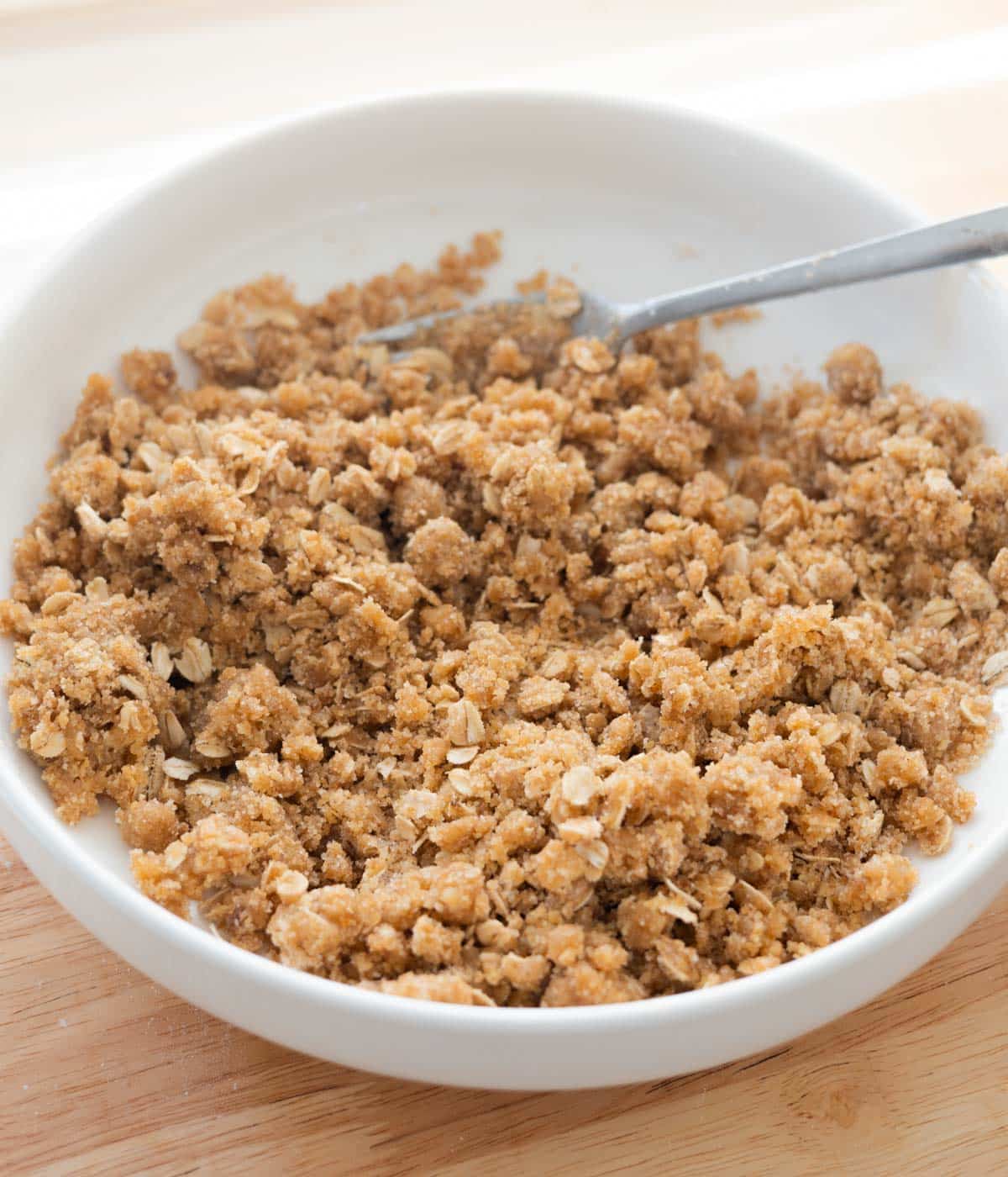 Homemade crumble topping in white mixing bowl.