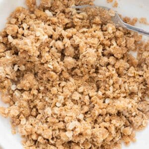 Homemade crumble topping in white bowl.