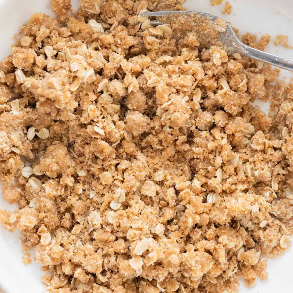 Homemade crumble topping in white bowl.