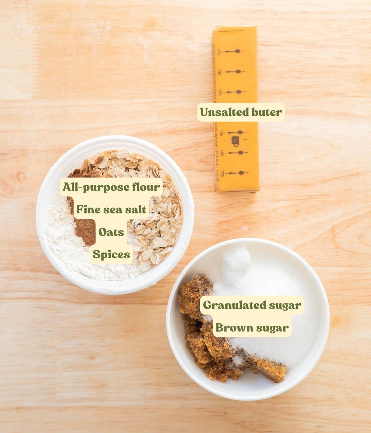 Labeled crumble topping ingredients laid out on wooden table.