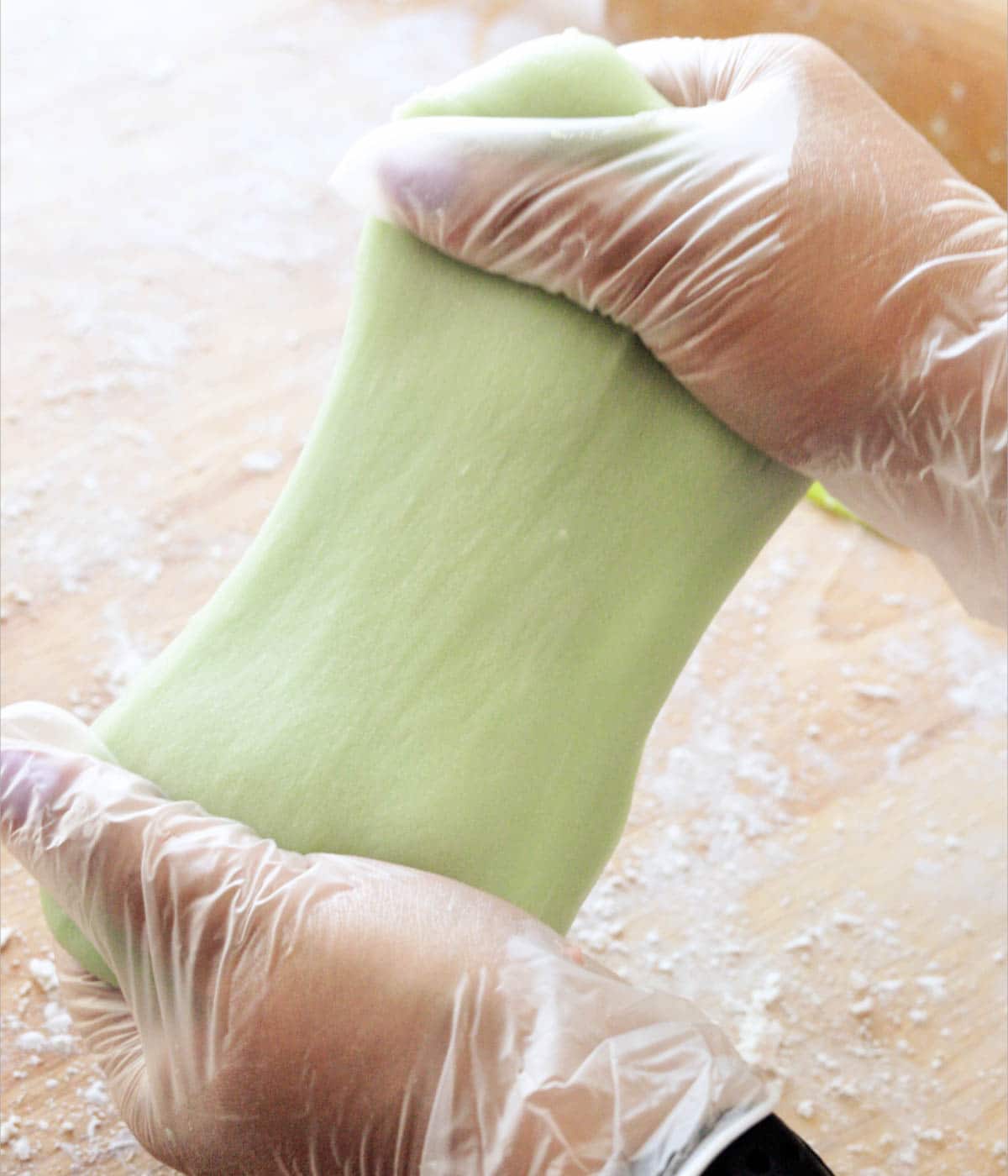 Kneading mint mochi dough in between hands.