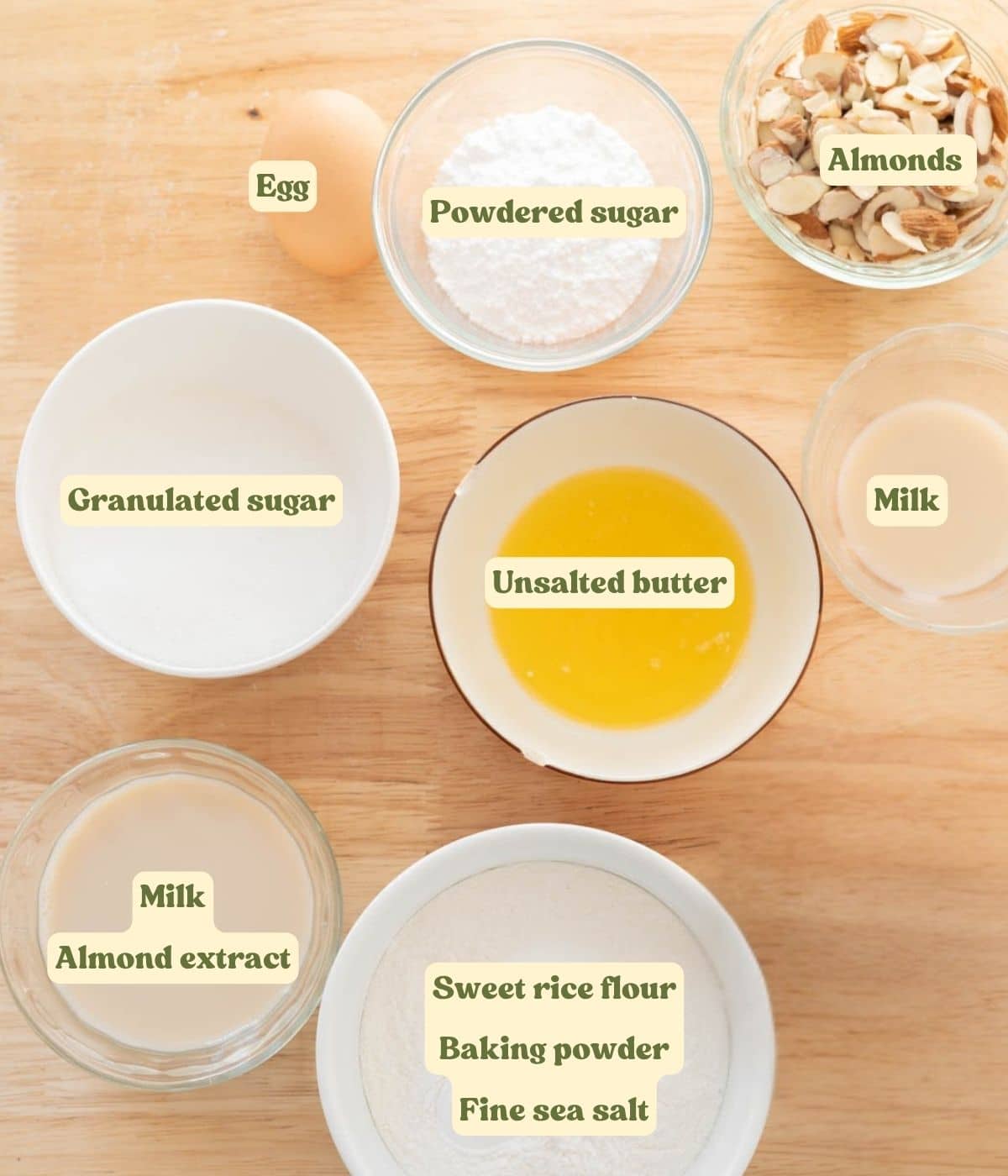 Labeled almond mochi donut ingredients laid out on wooden table.