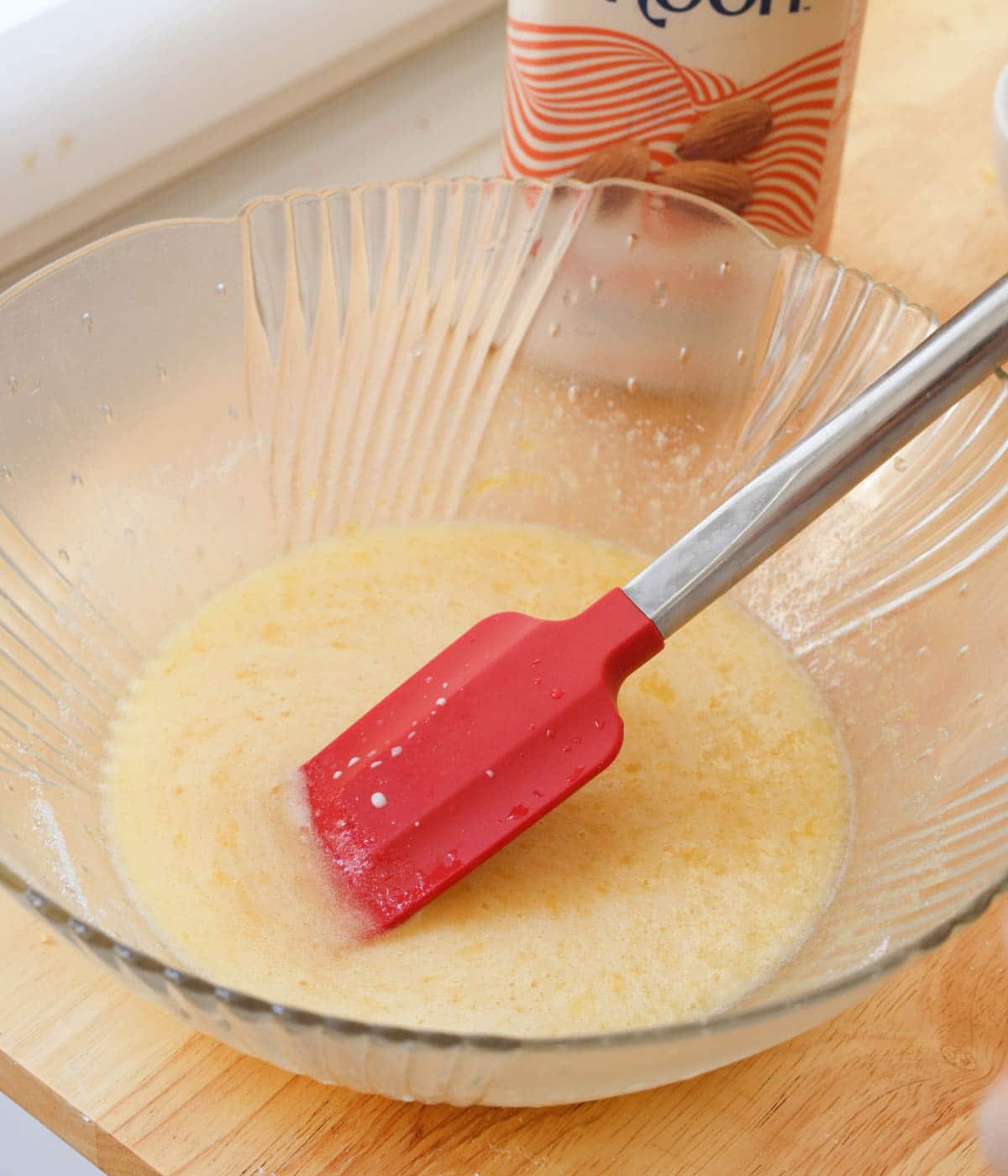 Wet ingredients mixed together in glass mixing bowl.