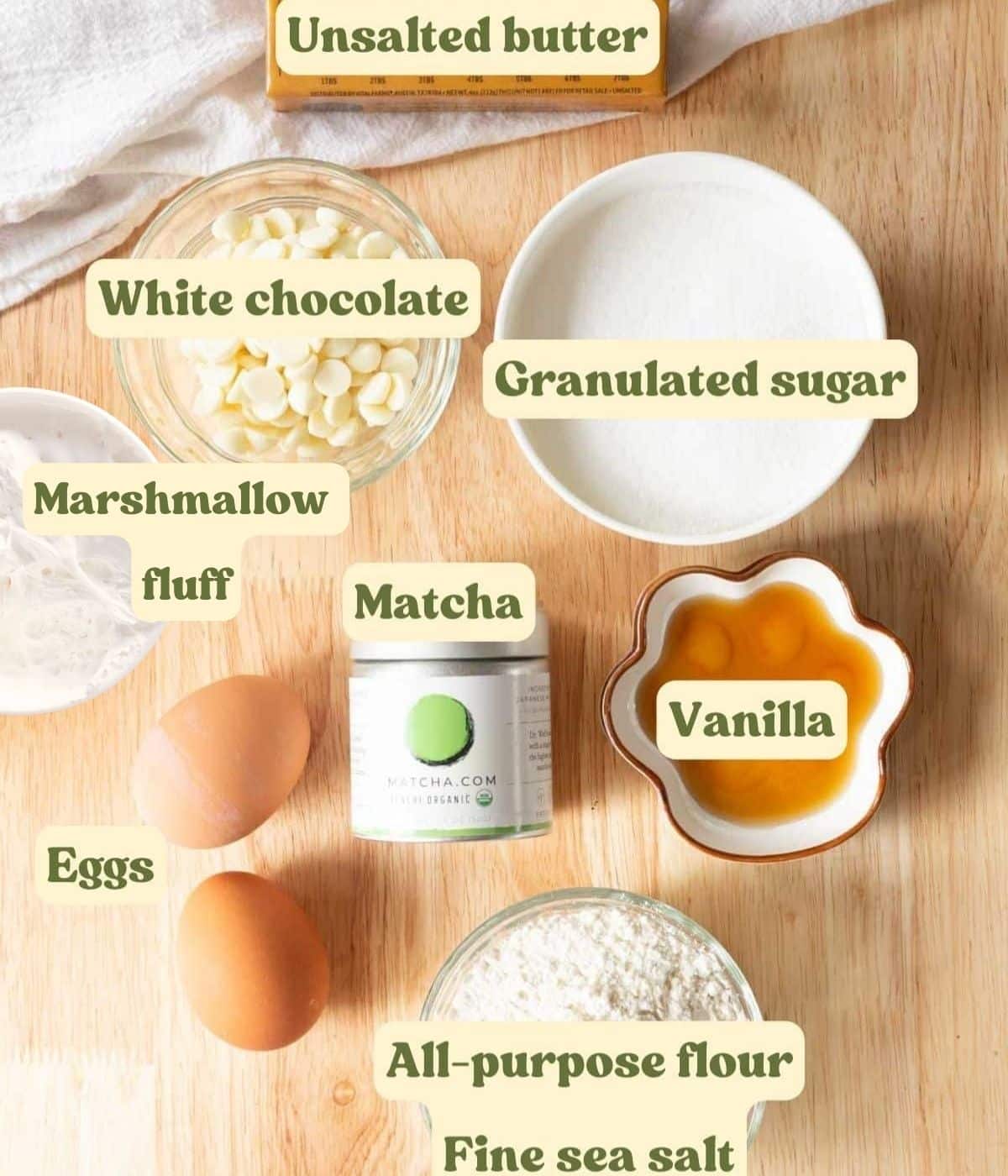 S'more matcha brownie ingredients laid out on a wooden table.