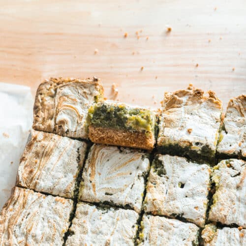 Cut pieces of s'mores matcha brownies on parchment.