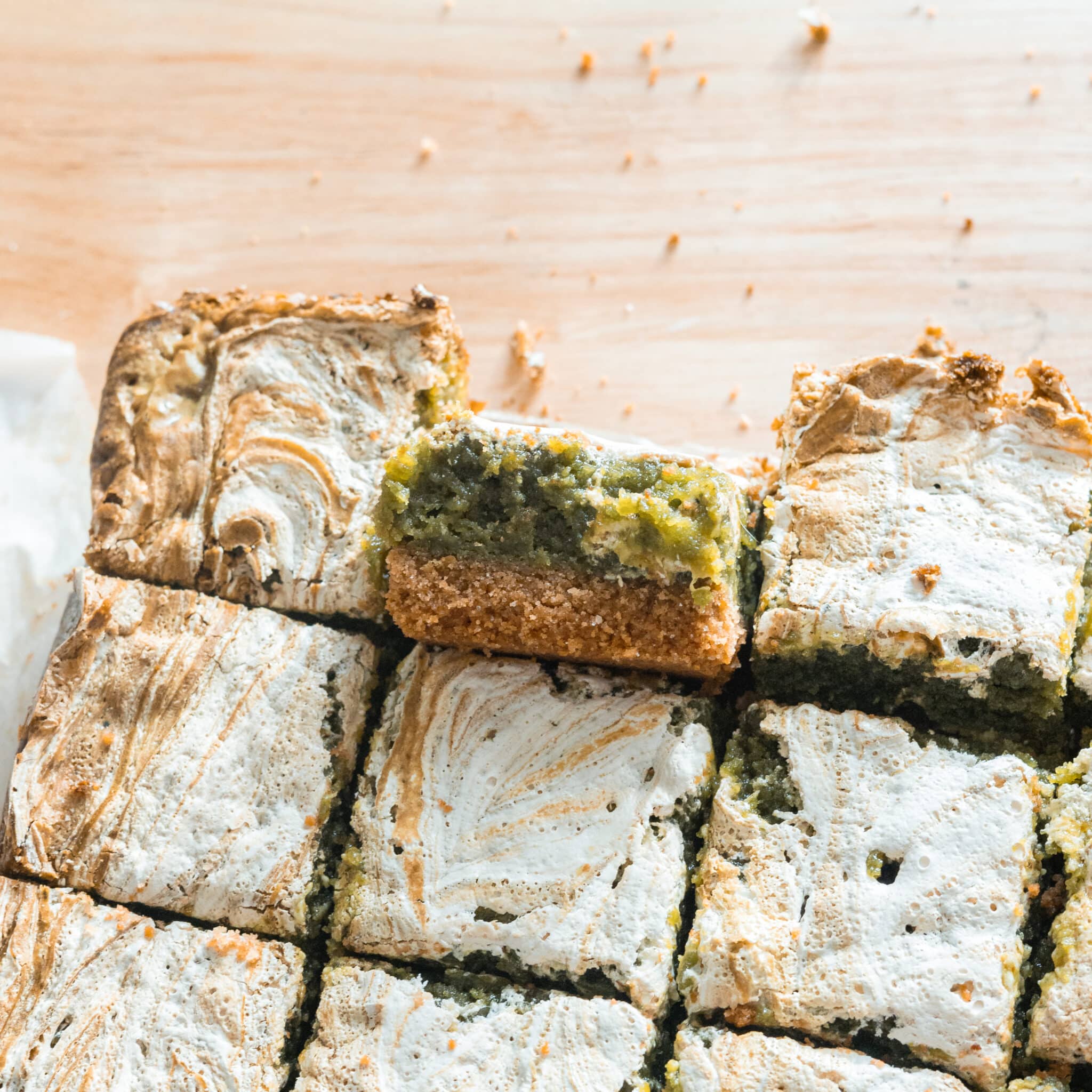 Cut pieces of s'mores matcha brownies on parchment.