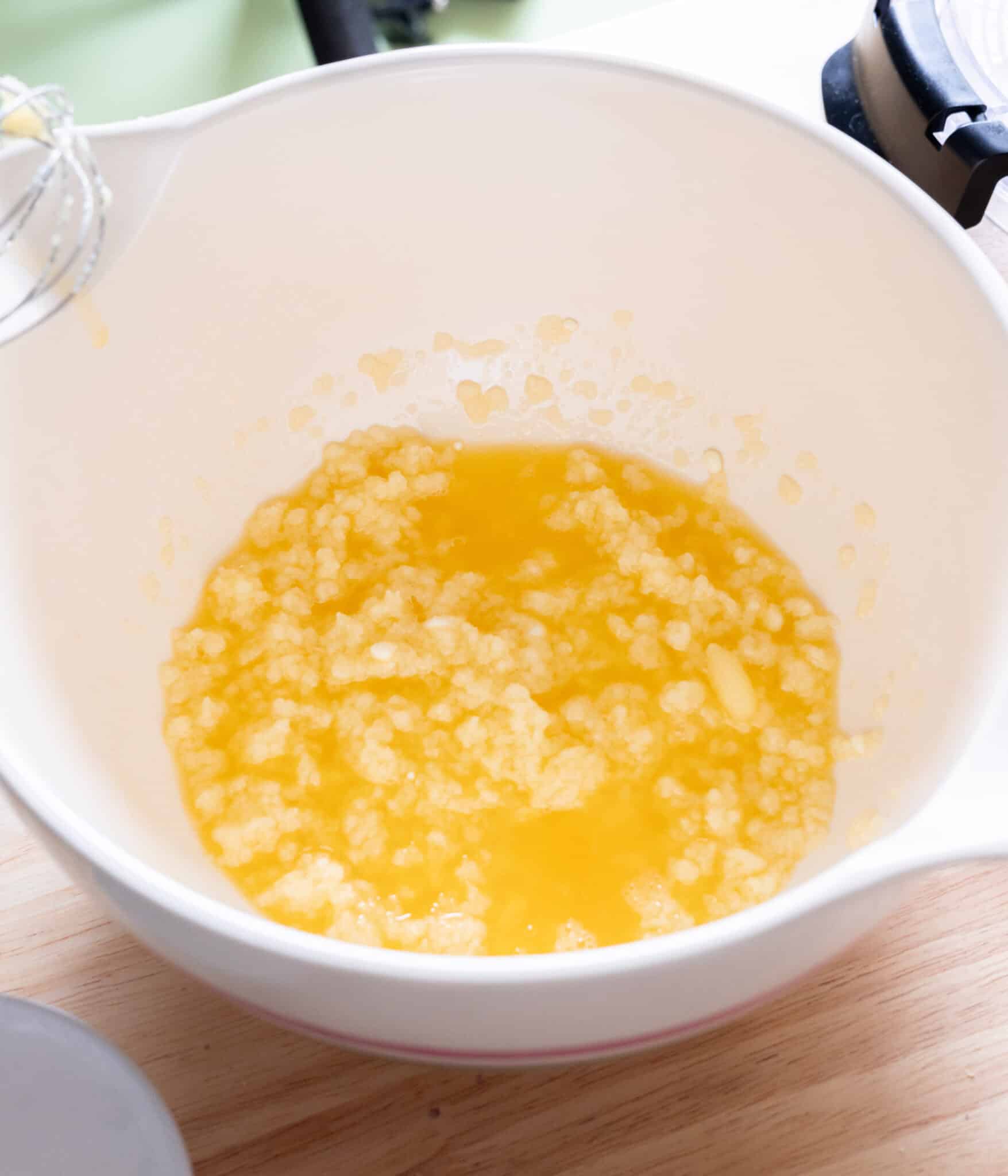Butter, sugar, and melted white chocolate mixed in a bowl.