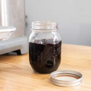 Dark cherry jam in a glass mason jar.
