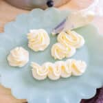 Piped swiss meringue buttercream on a plate.