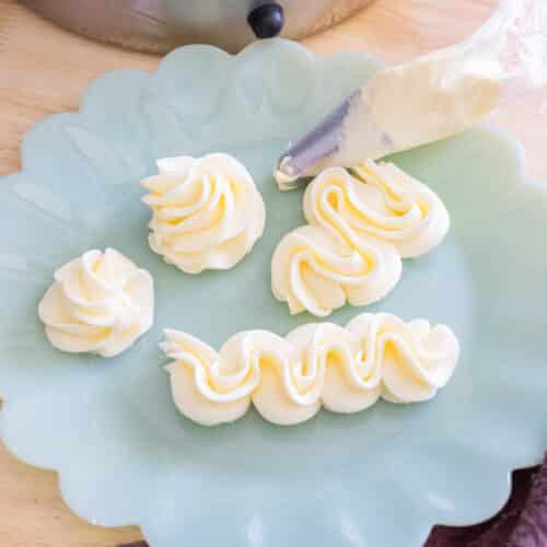 Piped swiss meringue buttercream on a plate.