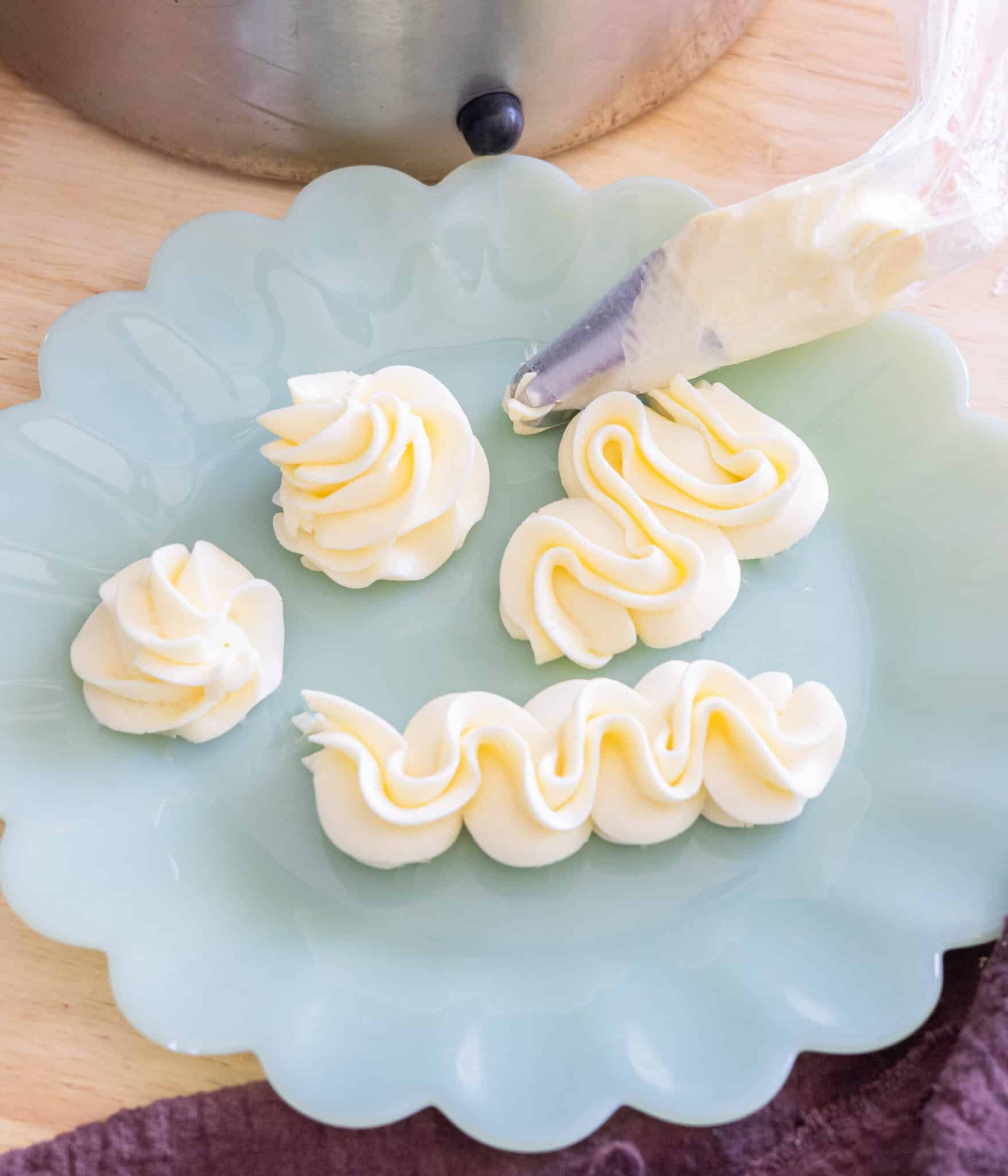 Piped swiss meringue buttercream on a plate.