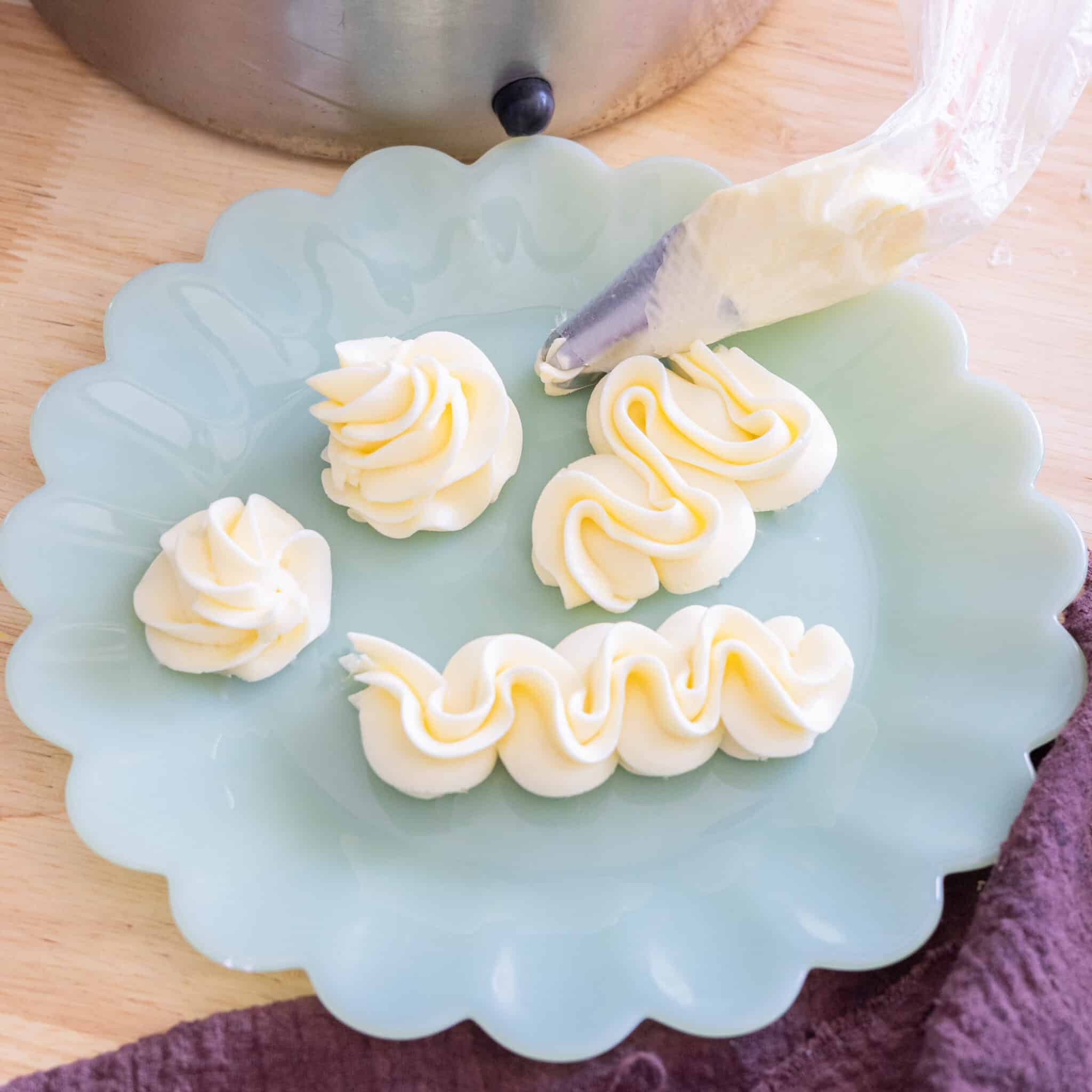 Piped swiss meringue buttercream on a plate.