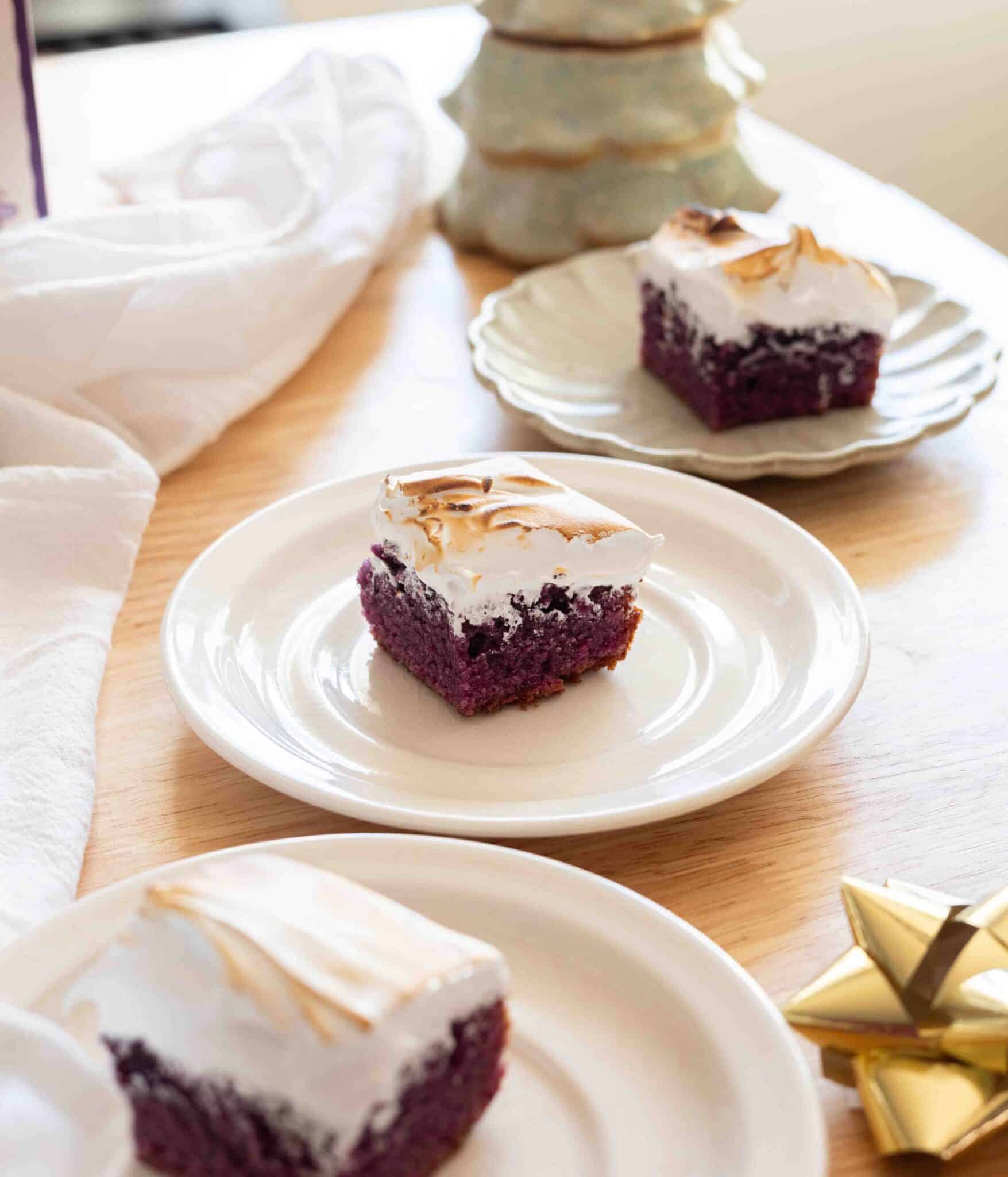 Ube blondies topped with Swiss meringue.