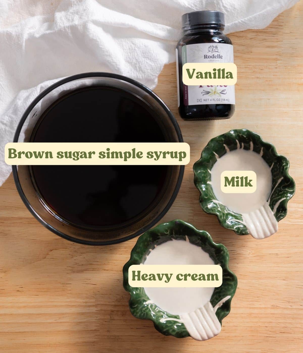 Labeled brown sugar cold foam ingredients laid out on wooden table.
