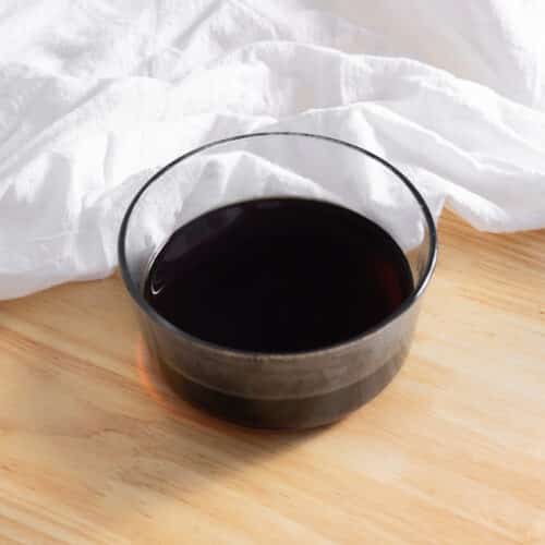 Brown sugar simple syrup in a glass container.