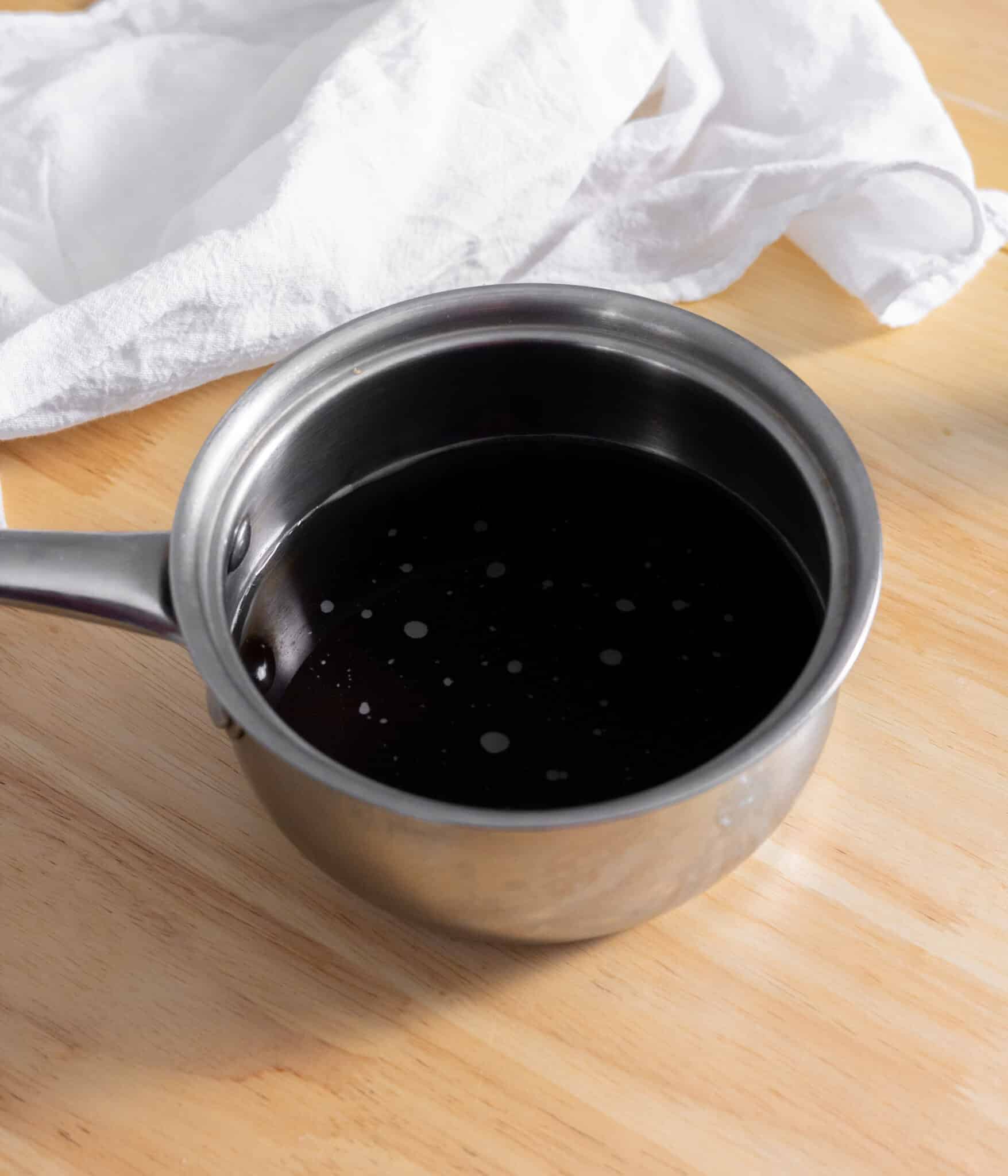 Brown sugar and water in a small pot, mixed together.