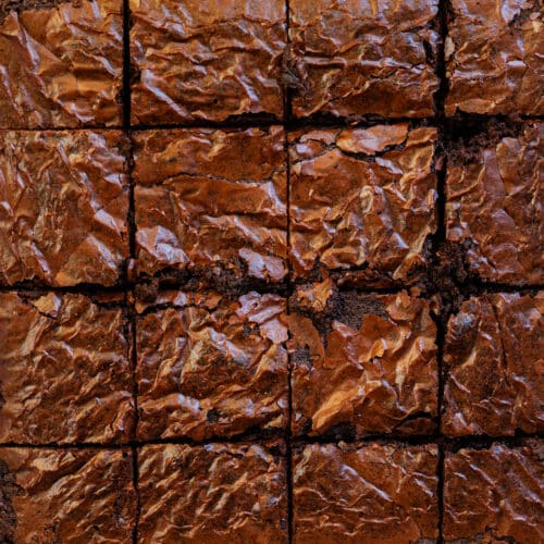 Crackle top brownies cut into 16 squares.