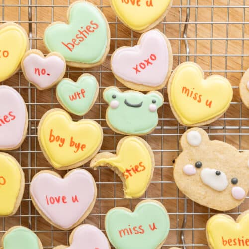 Conversation heart cookies on a wire rack.
