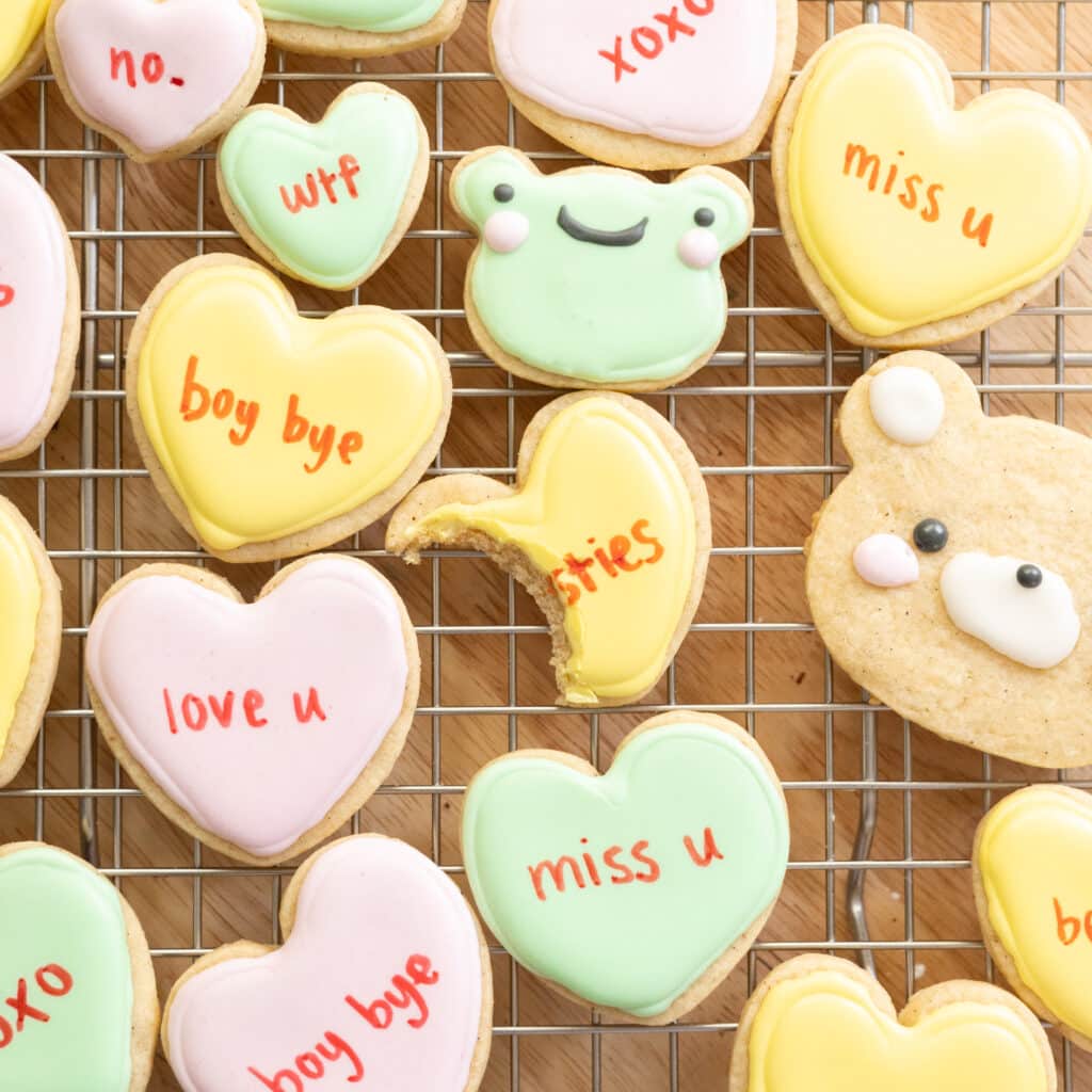 Conversation heart cookies on a wire rack.