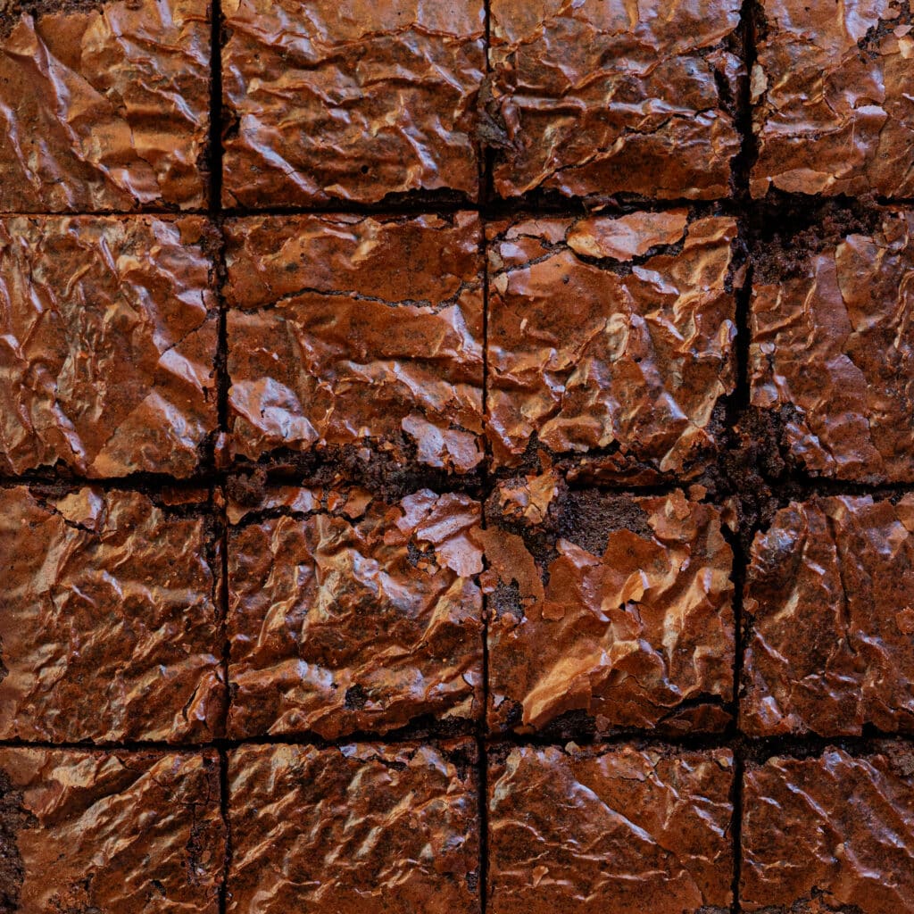 Crackle top brownies cut into 16 squares.