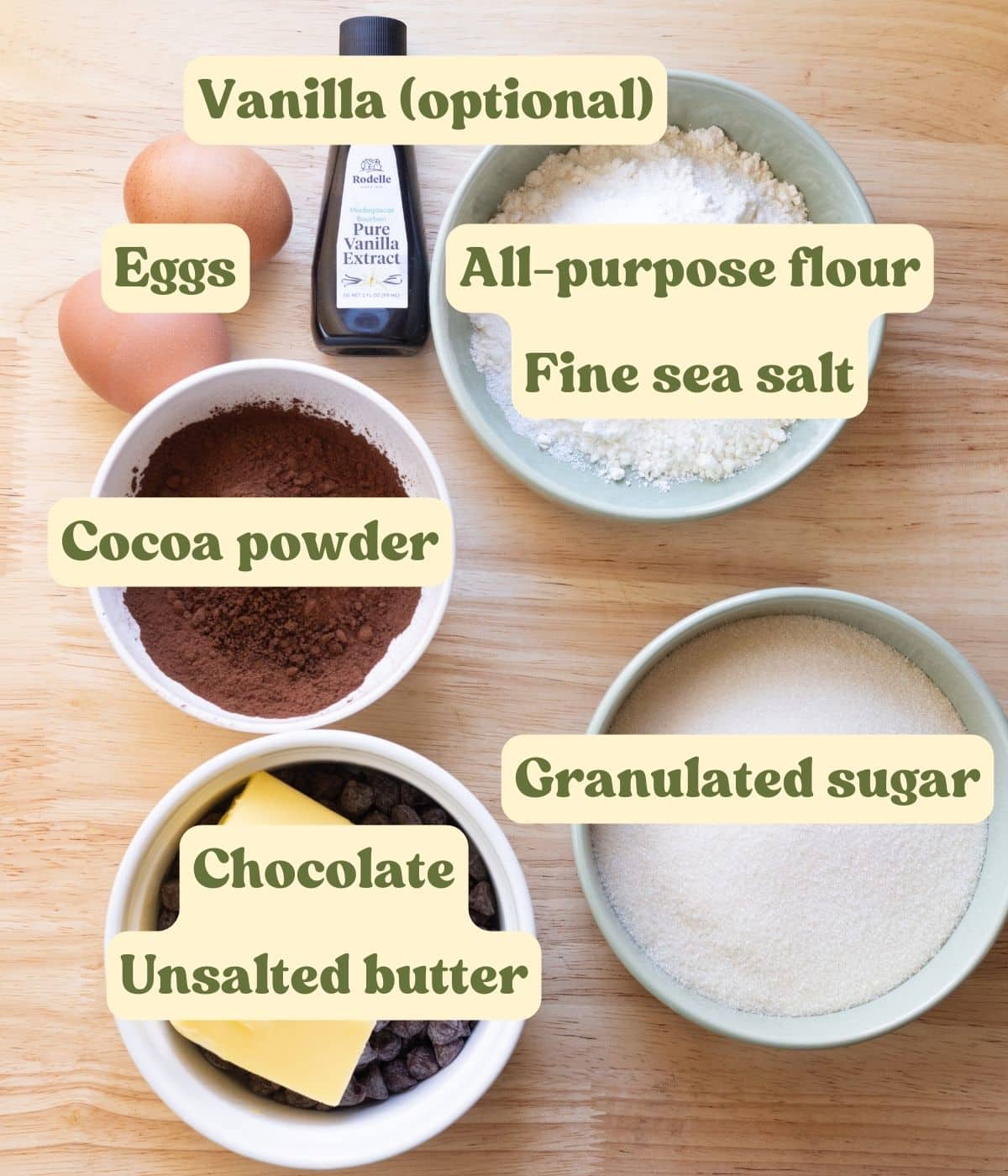 Brownie labeled ingredients laid out on a wooden table.