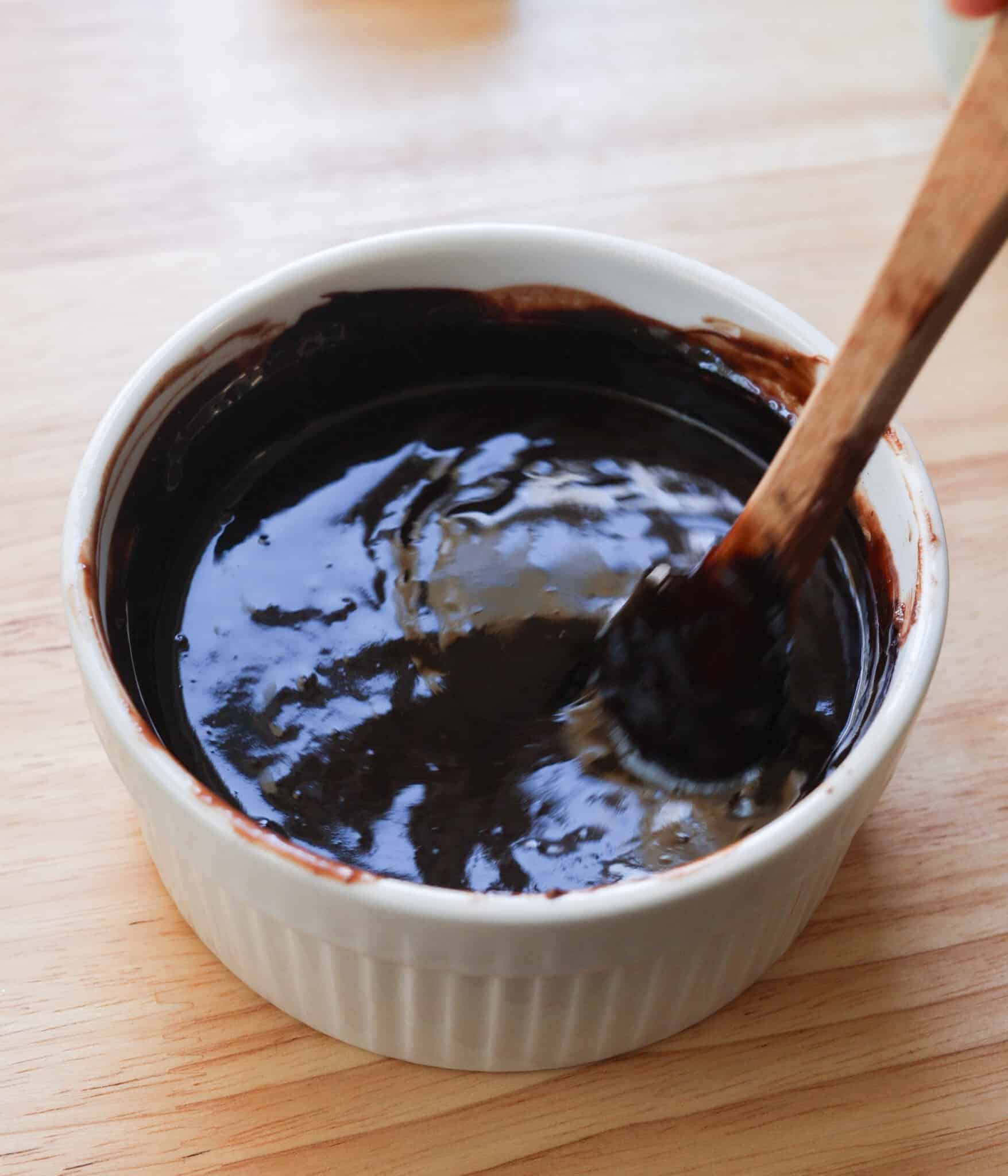 Melted butter, chocolate, and cocoa powder in a bowl.