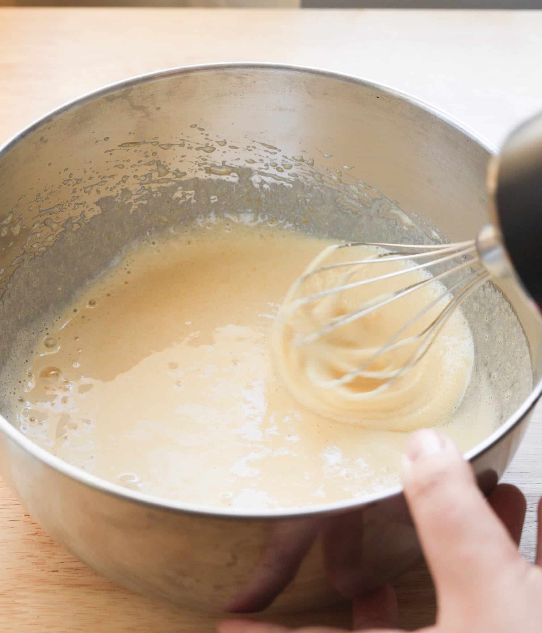 Whipped eggs and sugar in a mixing bowl.