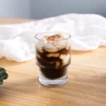 Einspanner topped with cocoa powder in a glass cup.