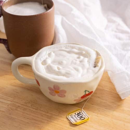 Homemade london fog in a cute mug, topped with cold foam.