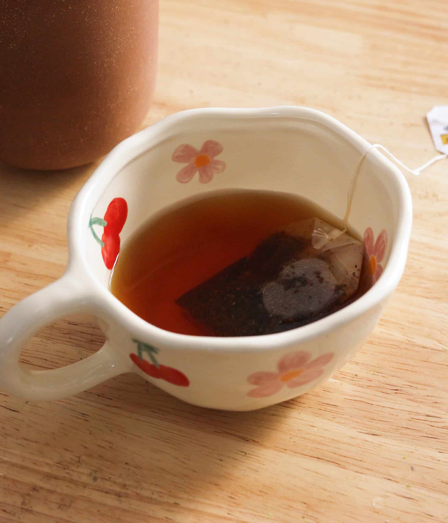 Brewed earl grey tea in a white mug.
