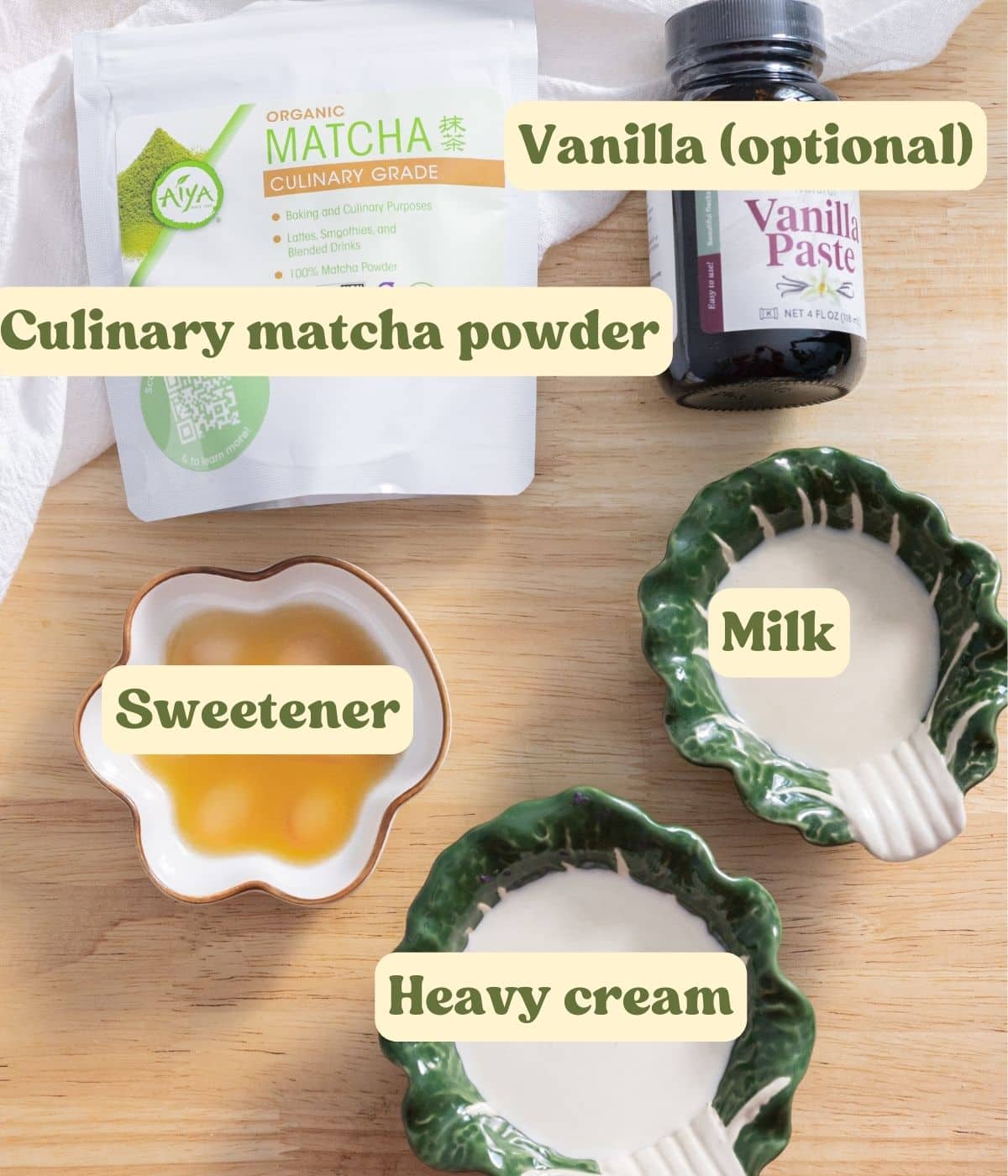Matcha cold foam labeled ingredients laid out on a wooden table.