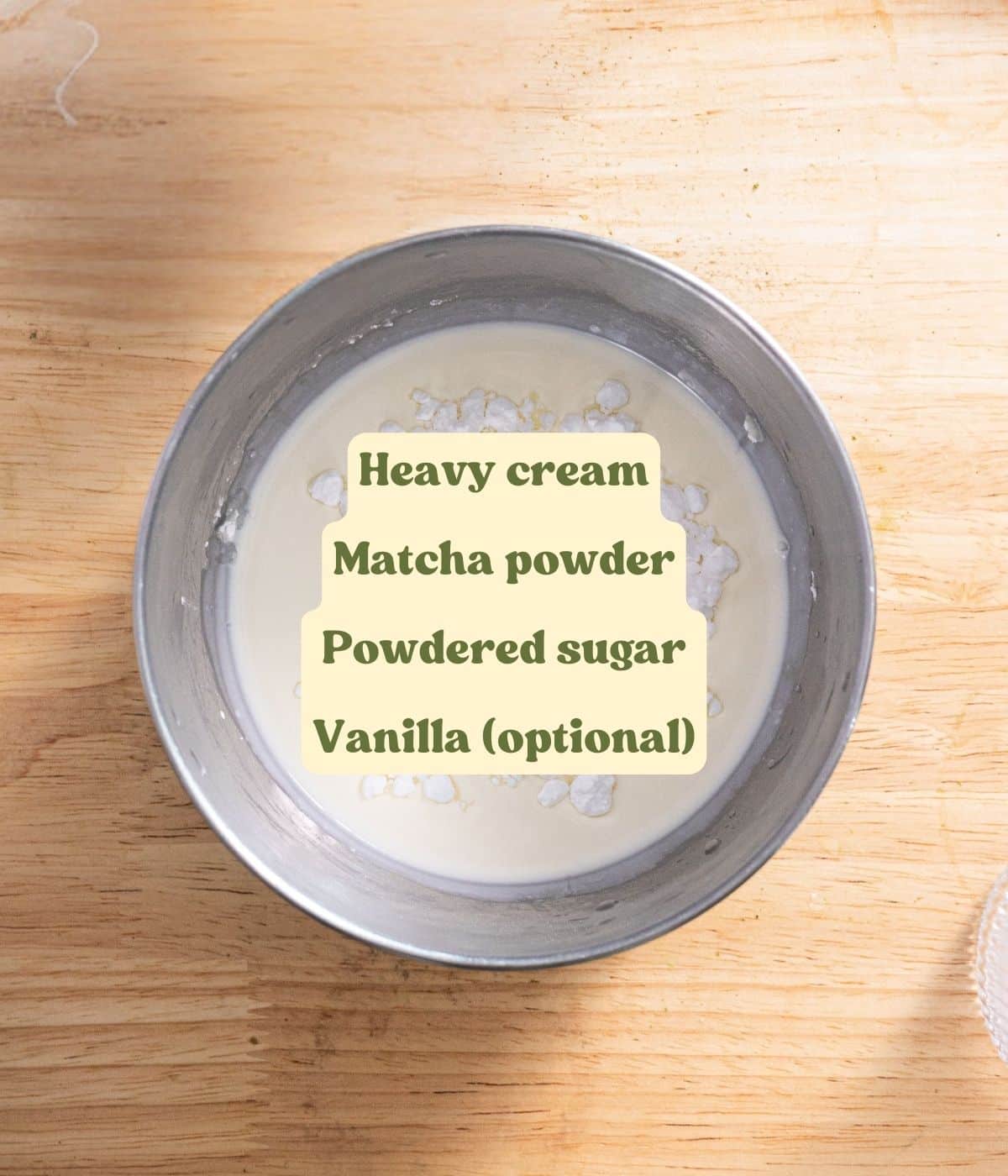 Matcha whipped cream labeled ingredients laid out on a wooden table.