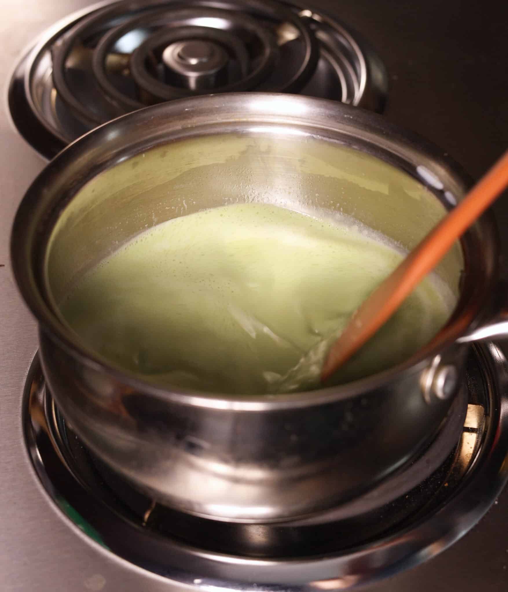 Stirring in matcha mixture to pot.