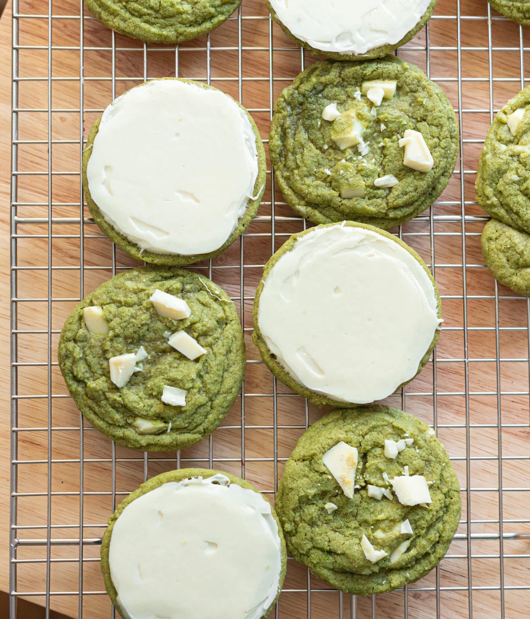 Matcha white chocolate cookies on a wire rack.