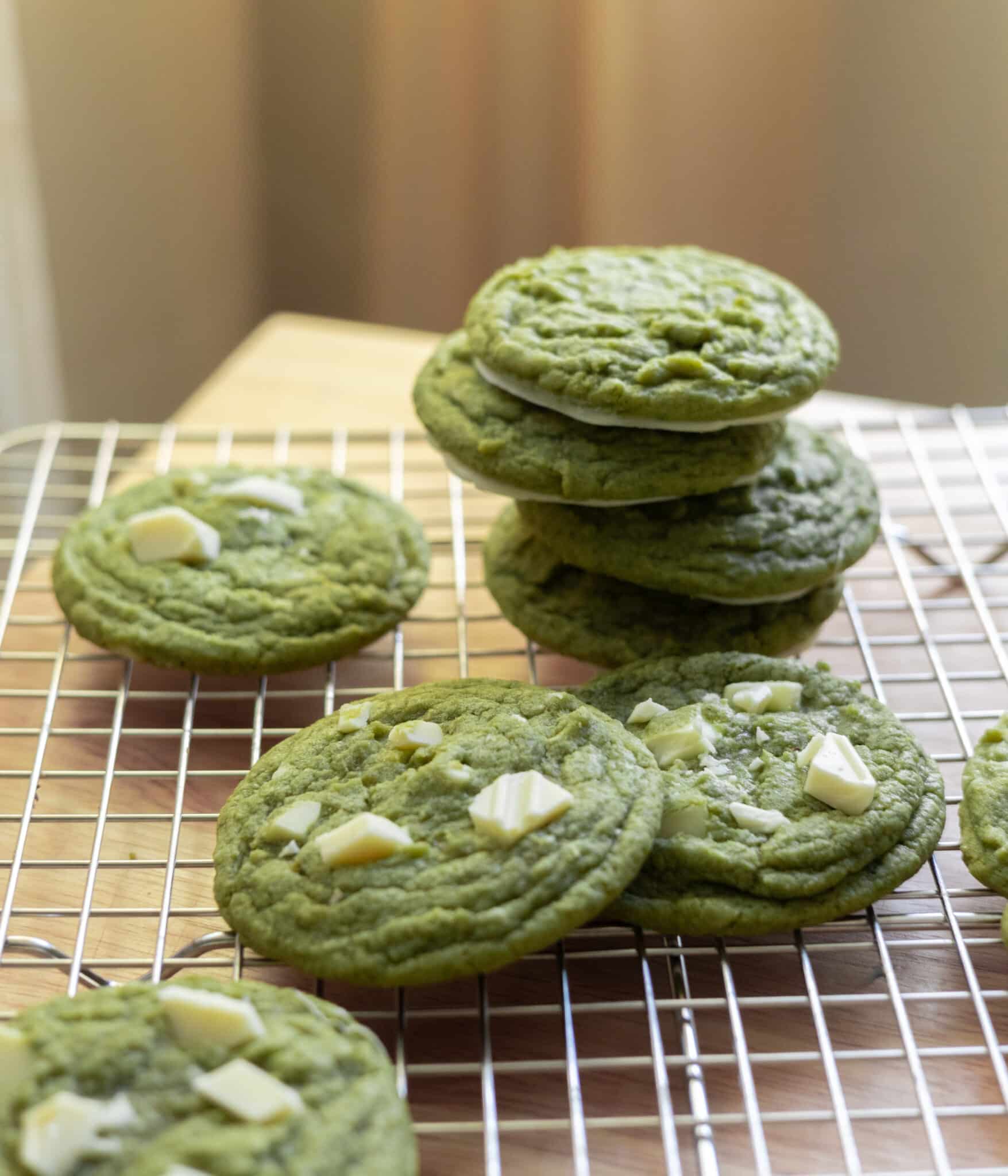 Matcha white chocolate chip cookies on a wire rack.