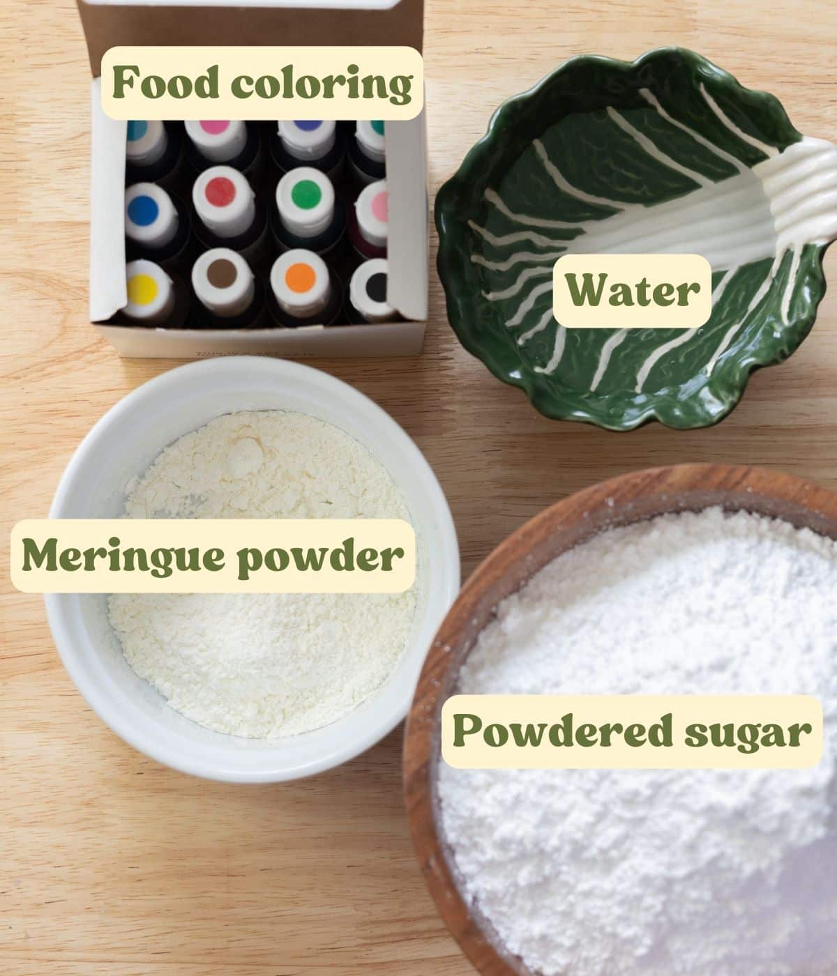 Royal icing labeled ingredients laid out on a wooden table.