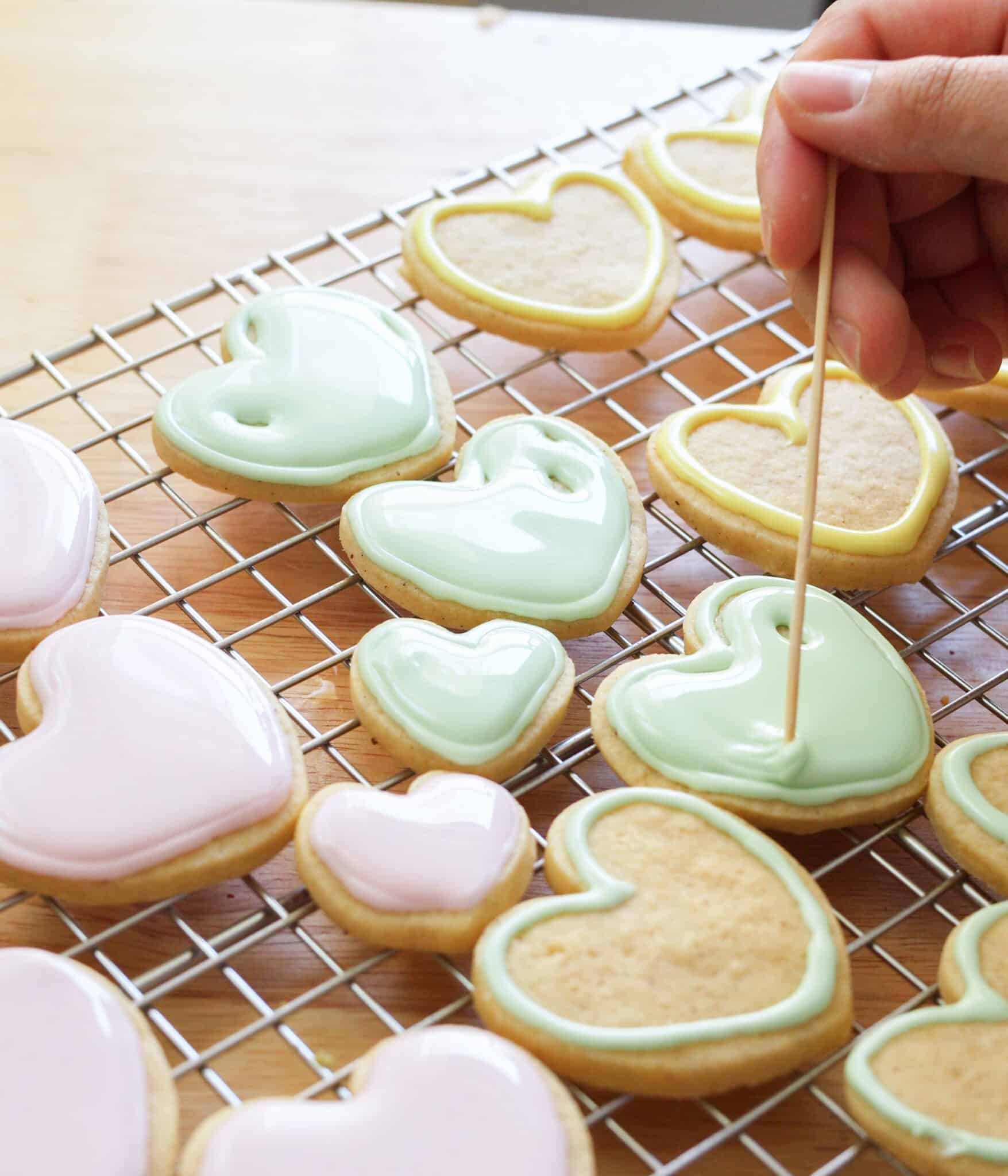 Flooding cookies with royal icing.