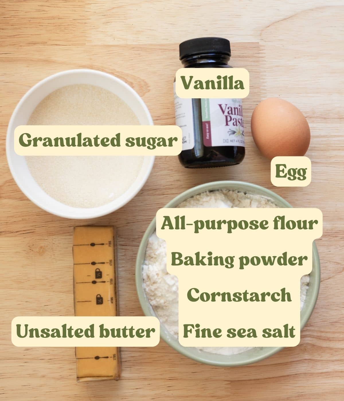 Vanilla cut out cookie labeled ingredients on a wooden table.